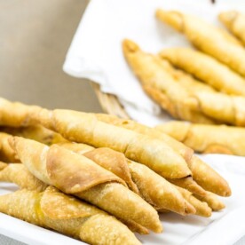 Plate and basket of Cameroonian fish rolls.