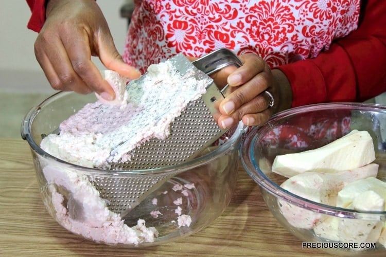 Grating ekwang on a box grater.