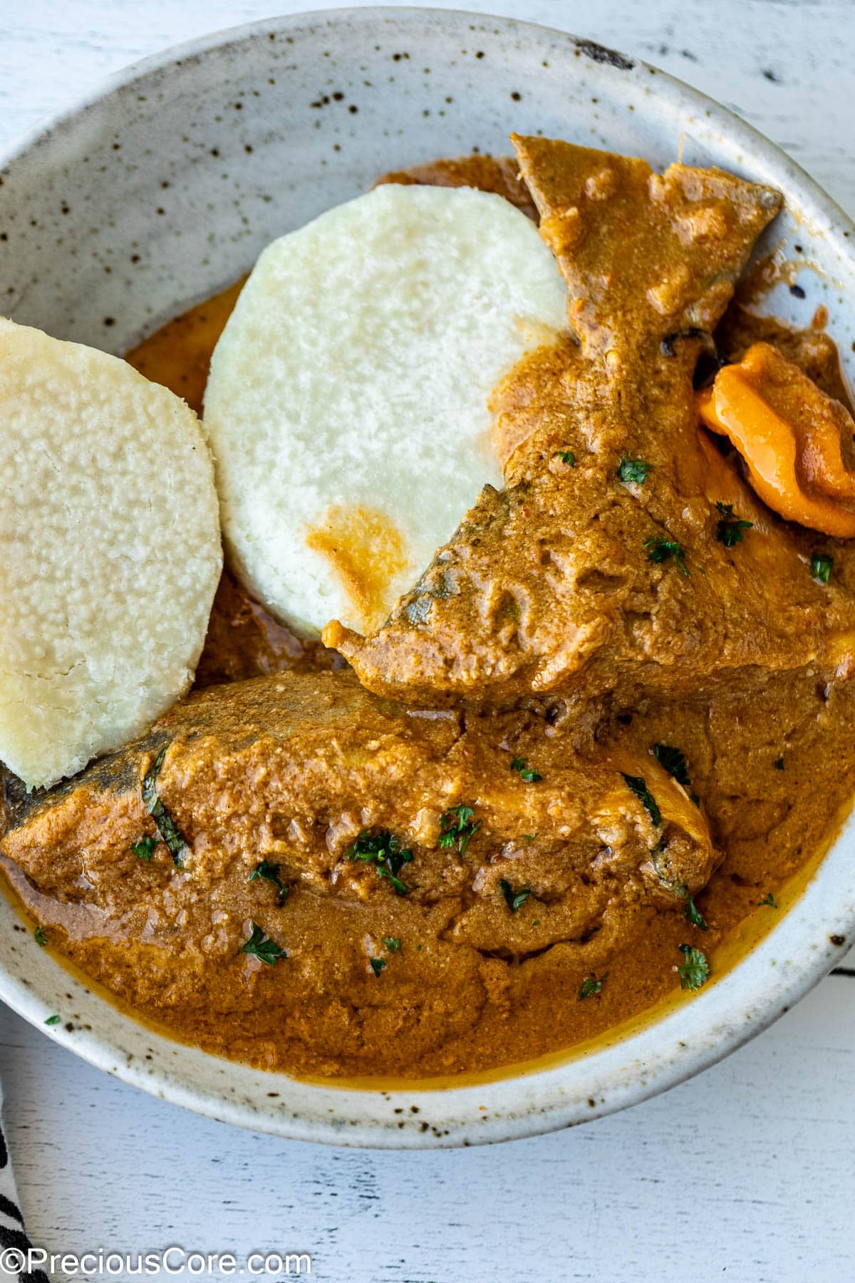 White yams and njangsa sauce in a bowl.