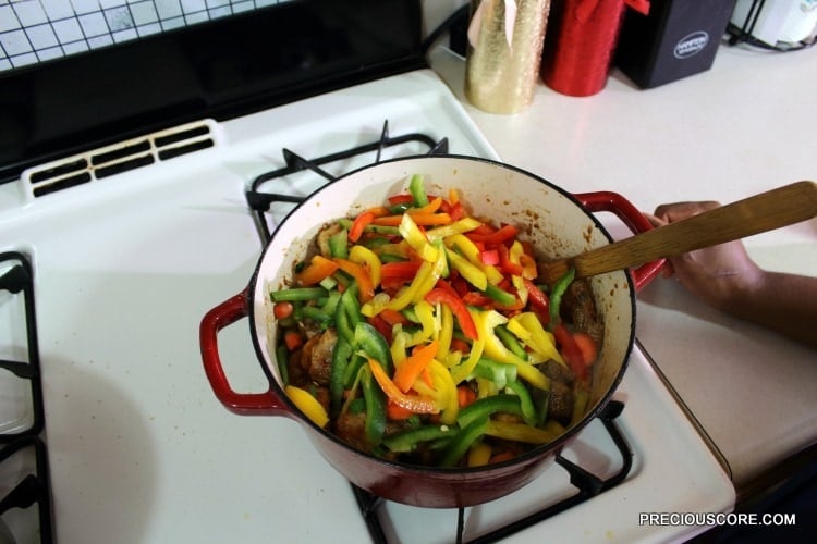 Colorful vegetables in a Dutch oven with chicken.