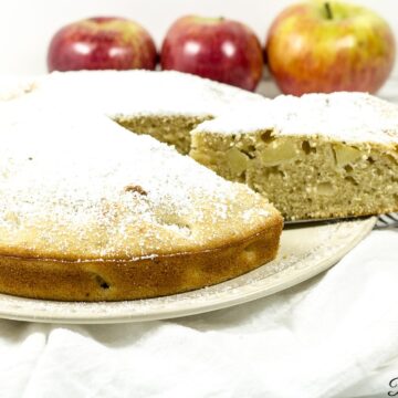 Apple cake with a slice being removed.