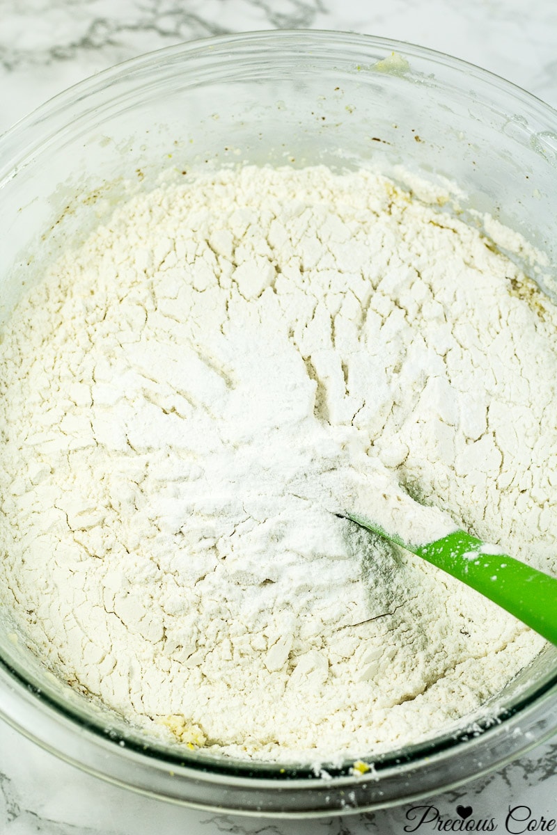 Flour added to wet ingredients for apple cake.