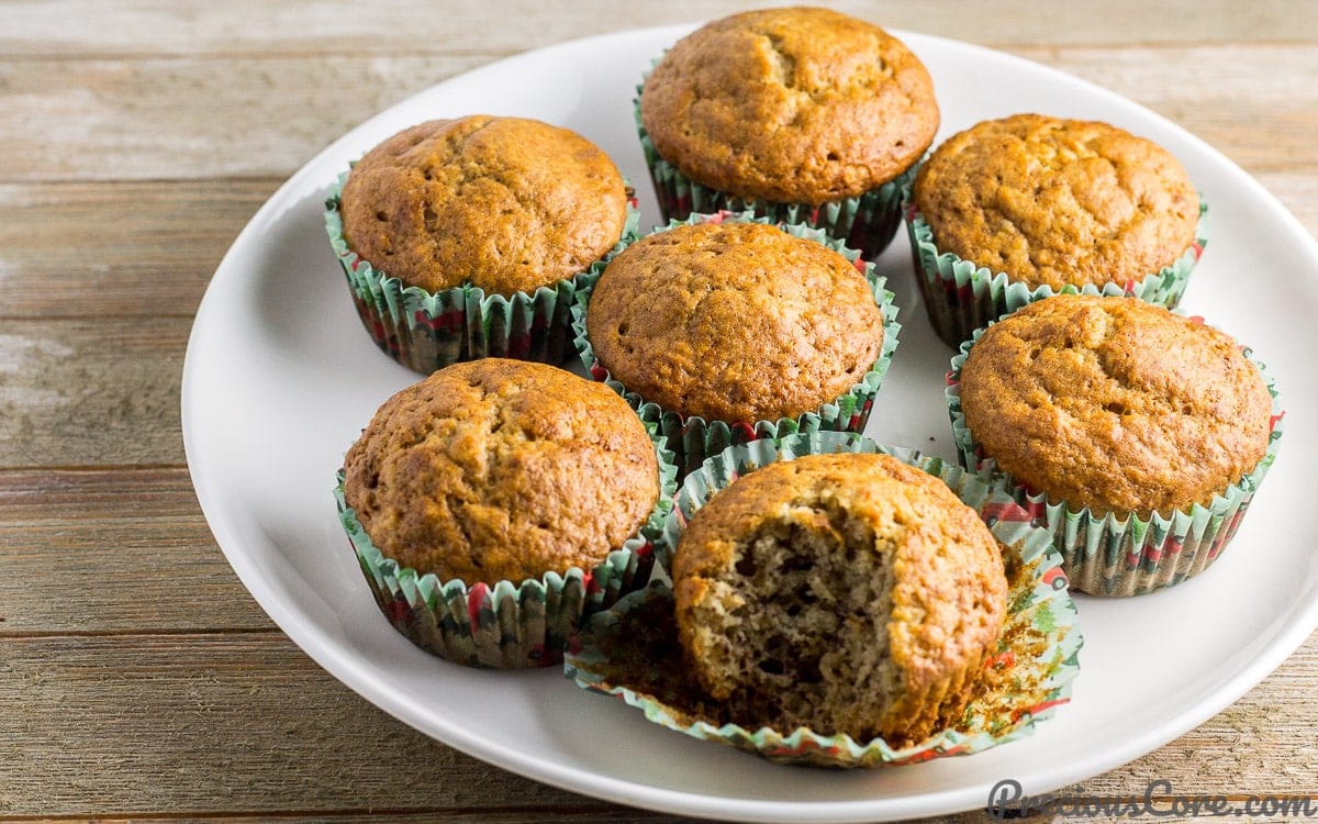 Cameroon banana cakes on a white plate, one missing a bite.