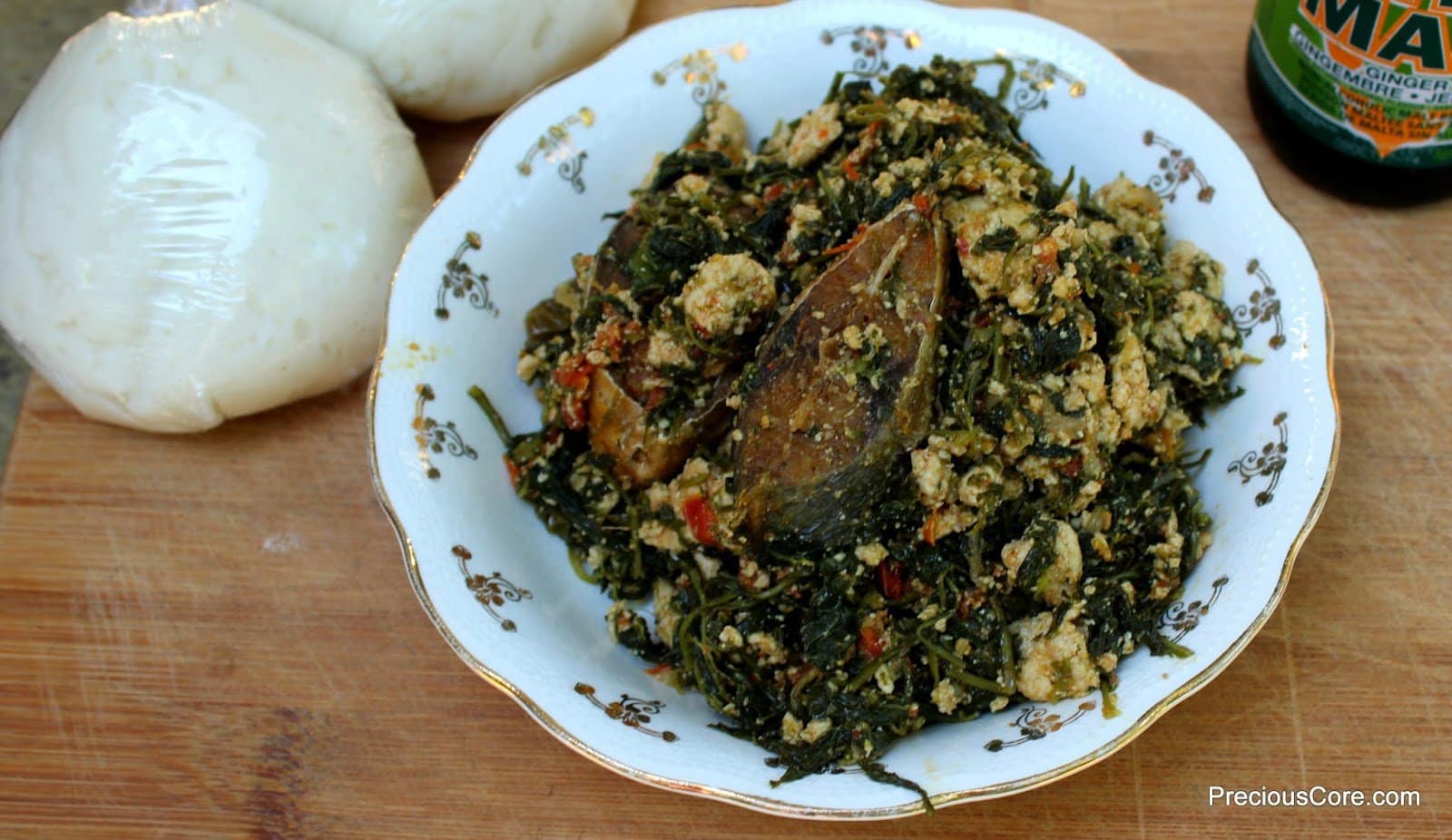 Njama Njama with Egusi in a white bowl.