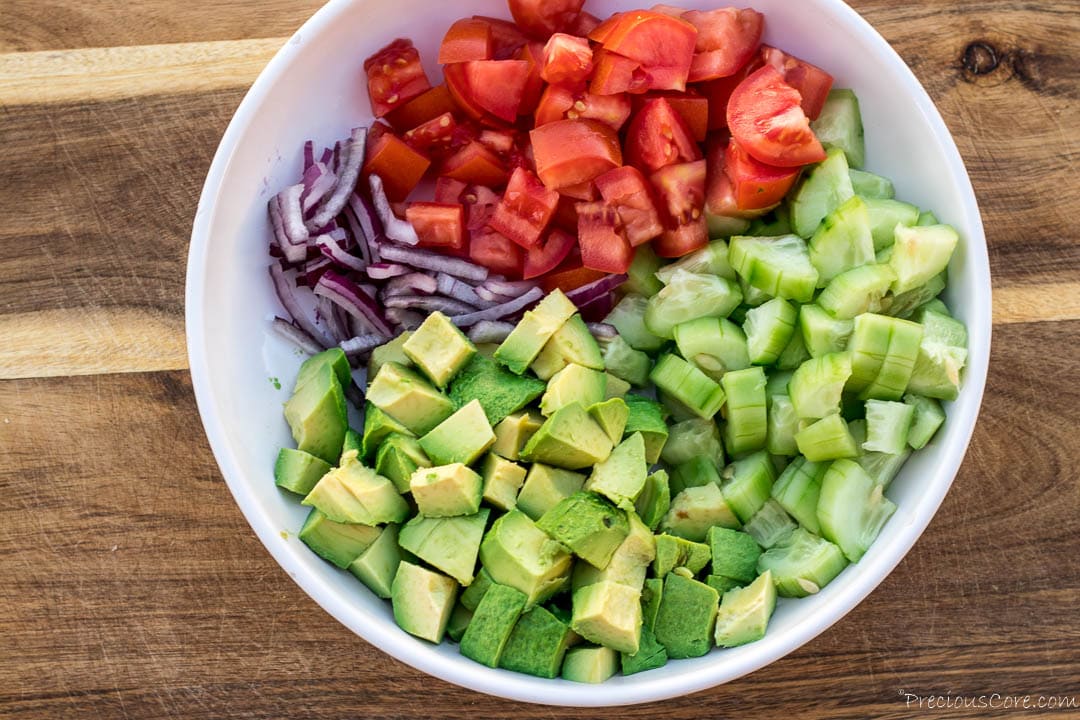 diced avocado, tomato, cucumber, onion in a bowl