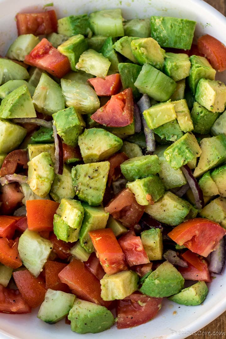 Bowl of avocado salad with tomatoes, onions, cucumber