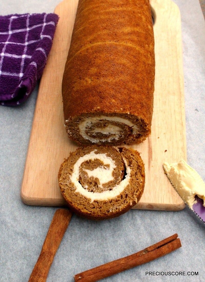 A Pumpkin Roll Cake on a chopping board