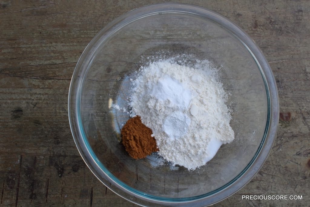 Dry cake ingredients in a glass mixing bowl.