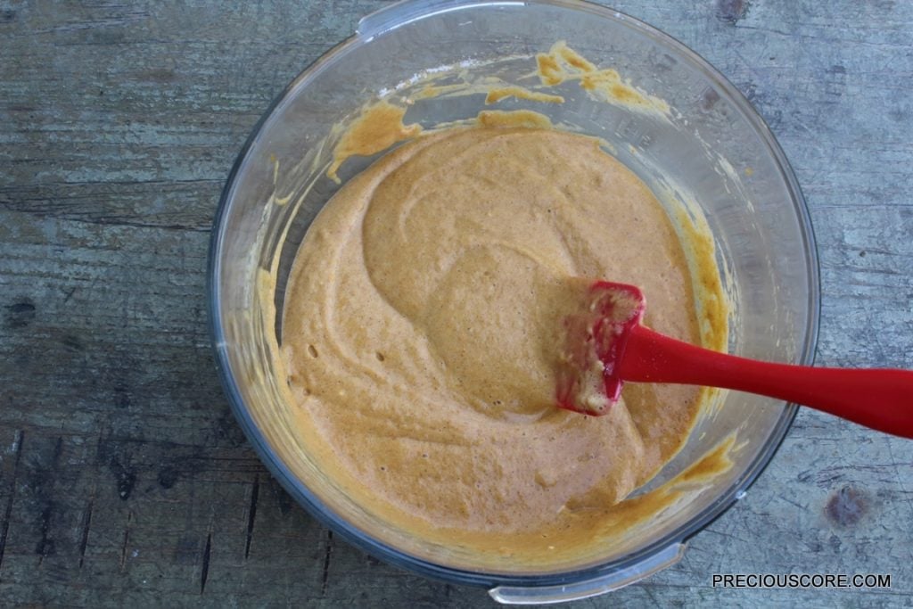 Bowl of pumpkin roll cake batter.