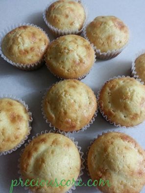 Coconut cup cakes on a counter.