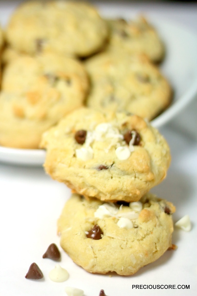 Stack of two coconut chocolate chip cookies.