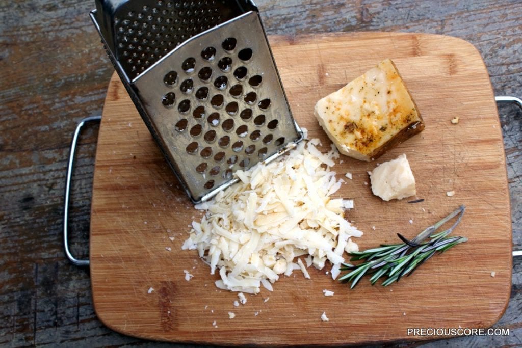 Parmesan cheese grated onto a cutting board.