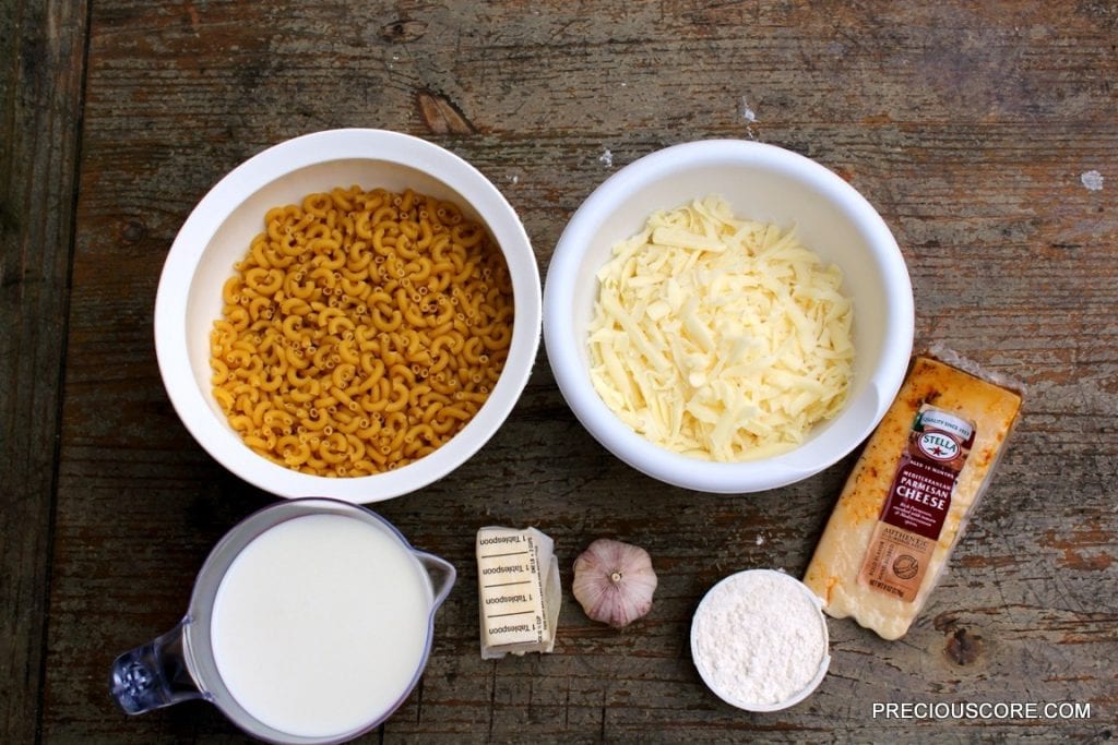 Macaroni and cheese ingredients including noodles, cheese, and garlic.