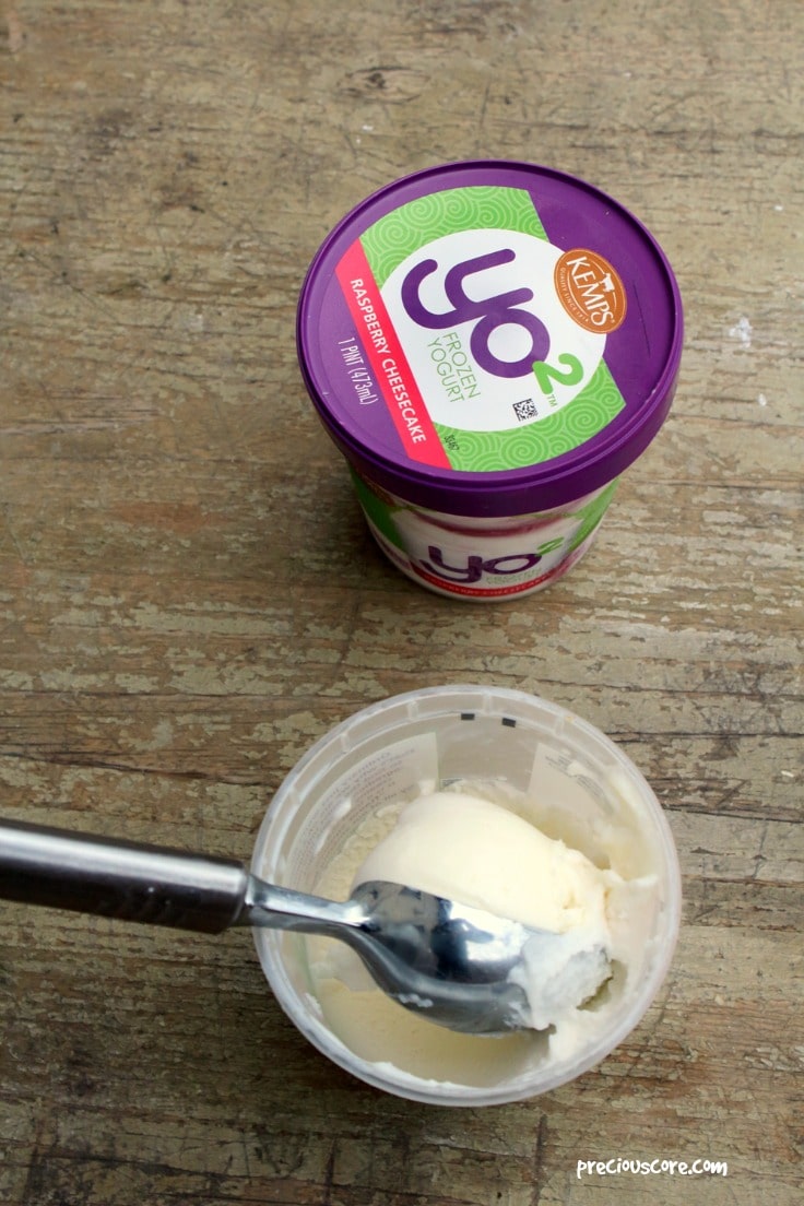 Spoon in a container of yo2 frozen yogurt.