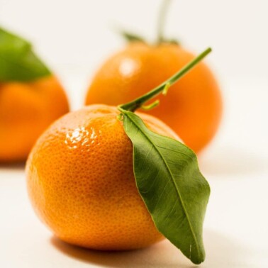 Tangerines still with their stems and leaves.