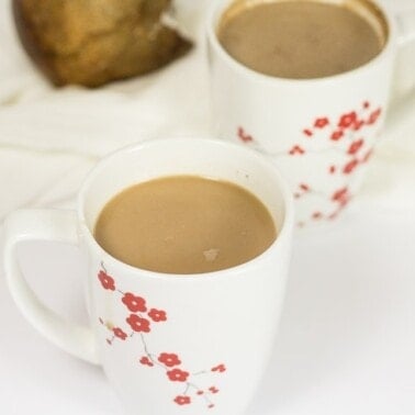 Two mugs of coconut hot chocolate.