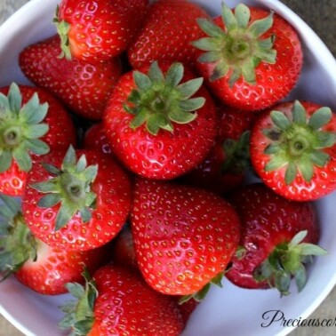 White bowl of whole strawberries.