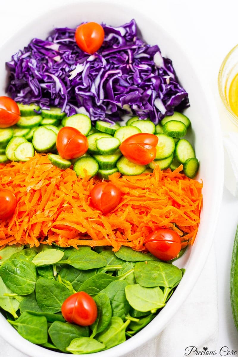 spinach cabbage salad with tomato hearts and honey lemon dressing