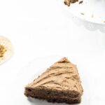 Slice of chocolate cake on a white background.