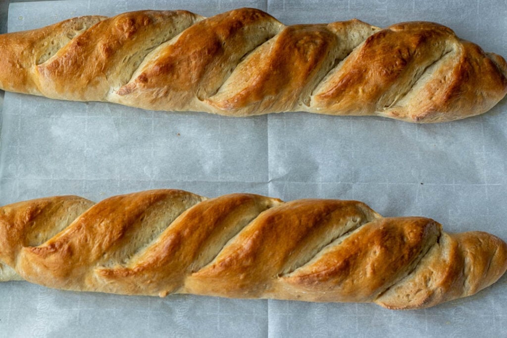 Freshly baked homemade French bread on baking sheet