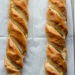 French bread loaves on large baking sheet