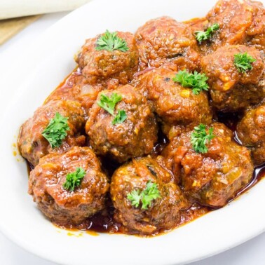 White dish of meatballs in tomato sauce - West African style.