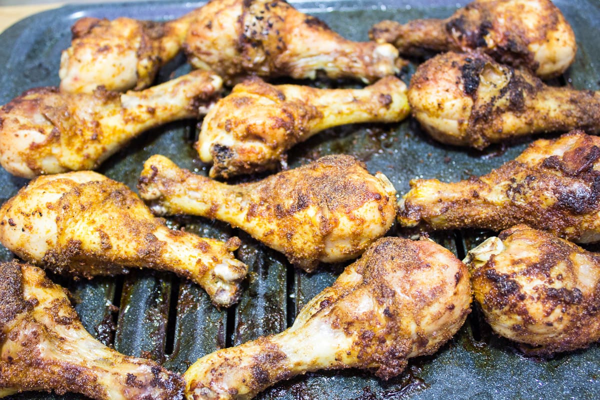 Chicken drumsticks on a broiling pan.