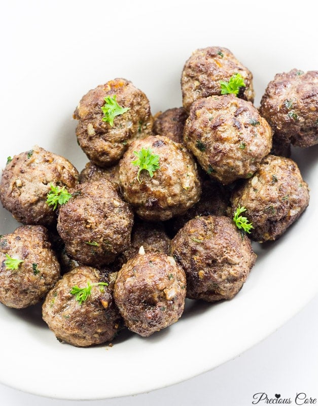 White dish of cooked meatballs.