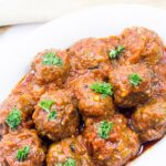 White dish of meatballs in tomato sauce - West African style.