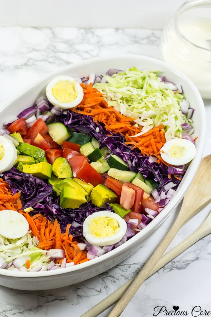 Cameroon salad with hard-boiled eggs, red onion, cucumber, and more.