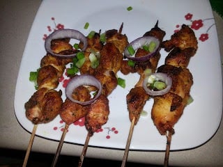 Chicken soya skewers on a plate.