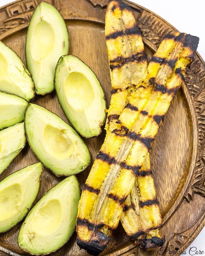 Plate with grilled plantains and avocado wedges.