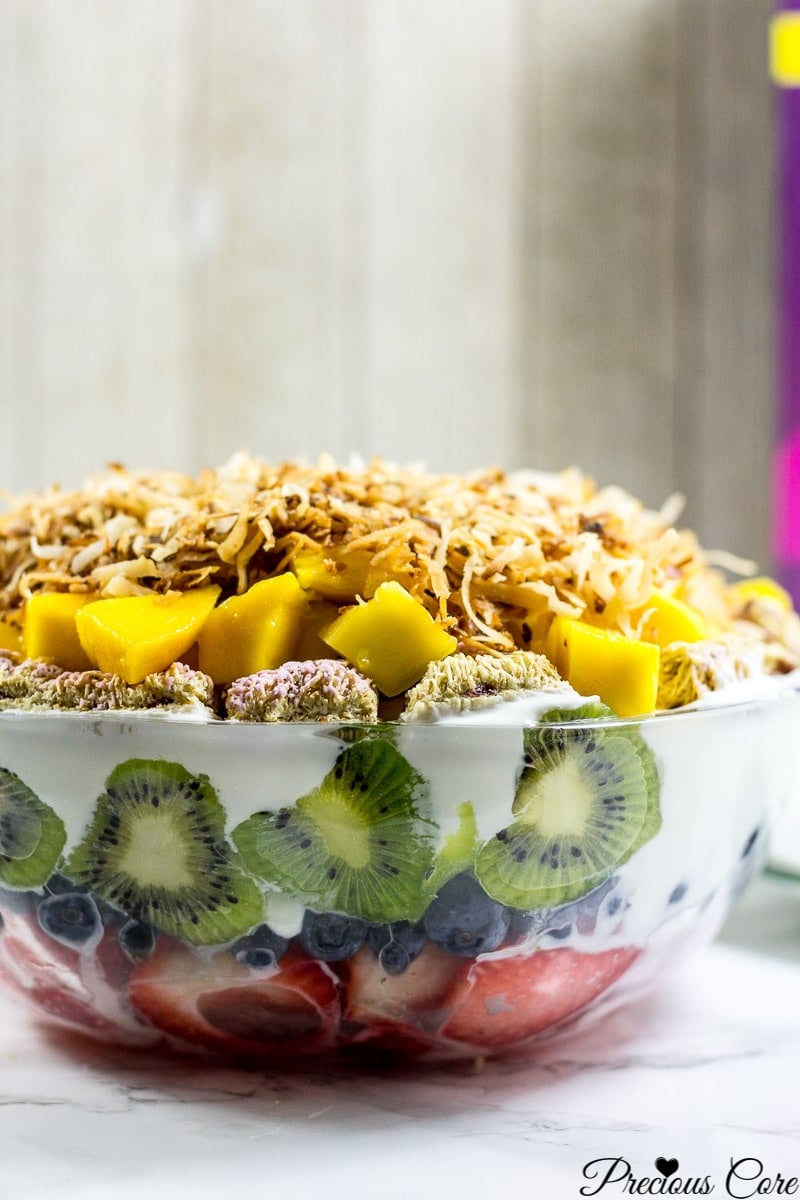 Seven layer fruit salad in a glass bowl.