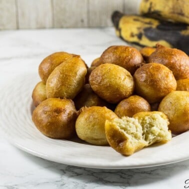 Plantain puff puffs on a white plate.