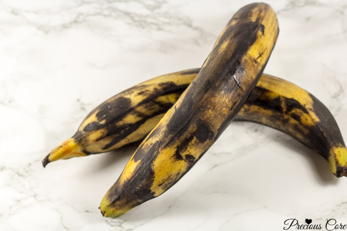 Very brown plantains on a marbled countertop.