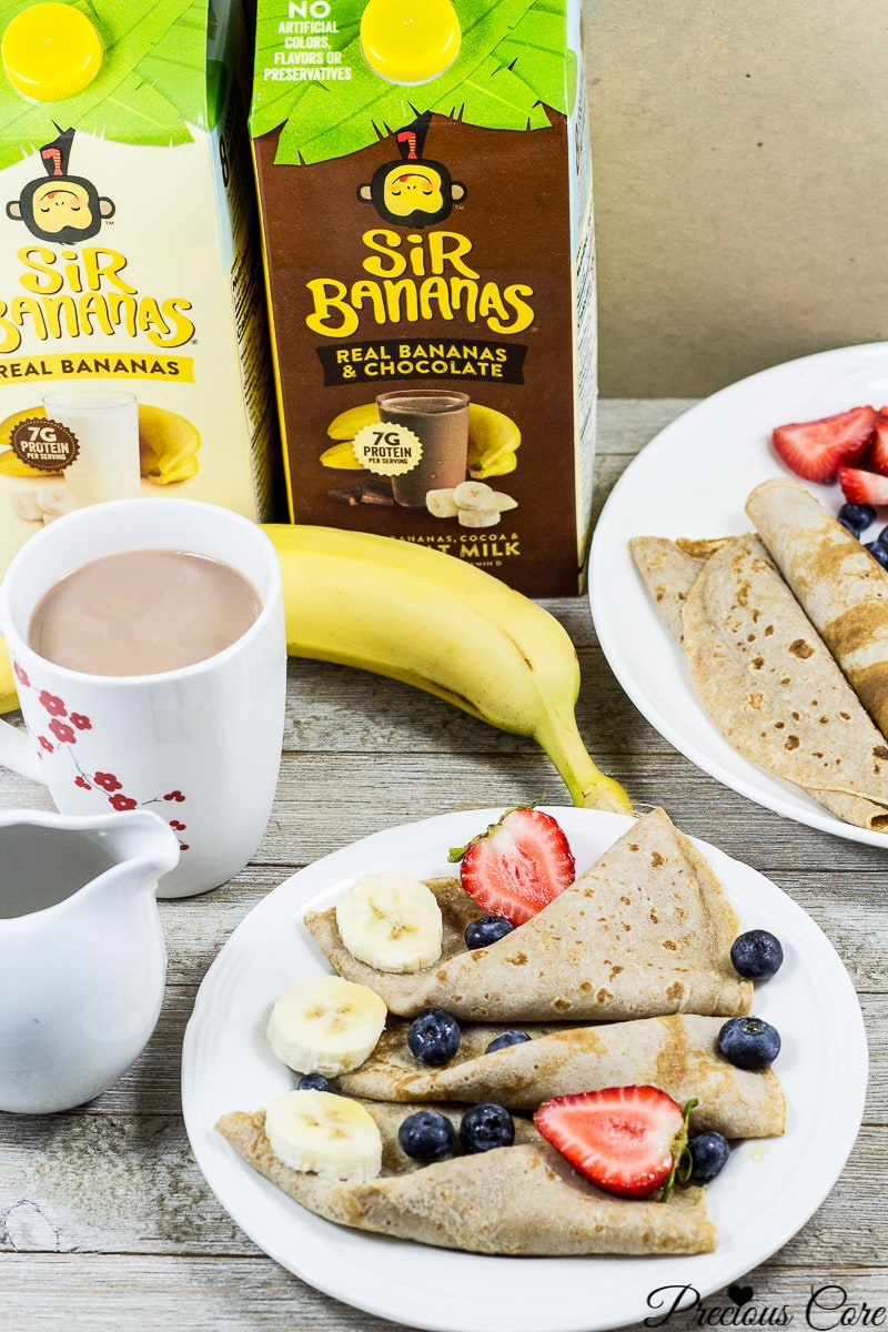 Plates of banana crepes with containers of Sir Bananas milk.