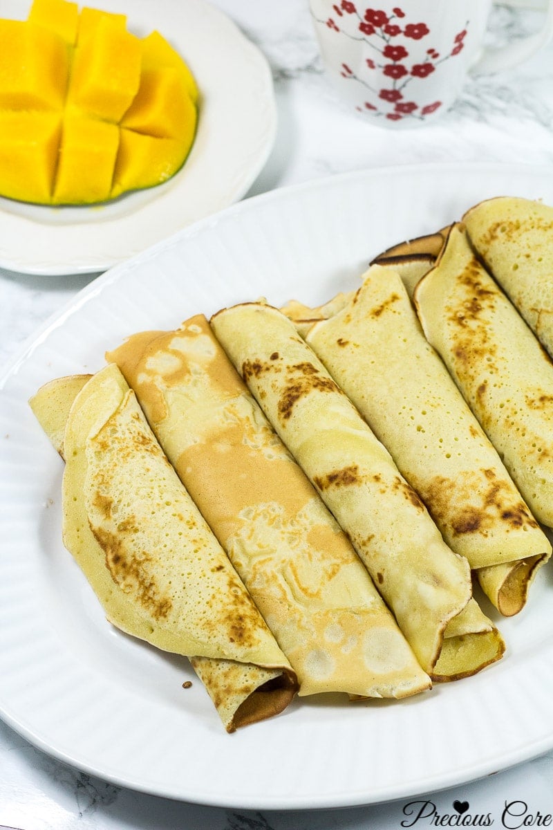 Large plate of rolled Cameroonian pancakes.