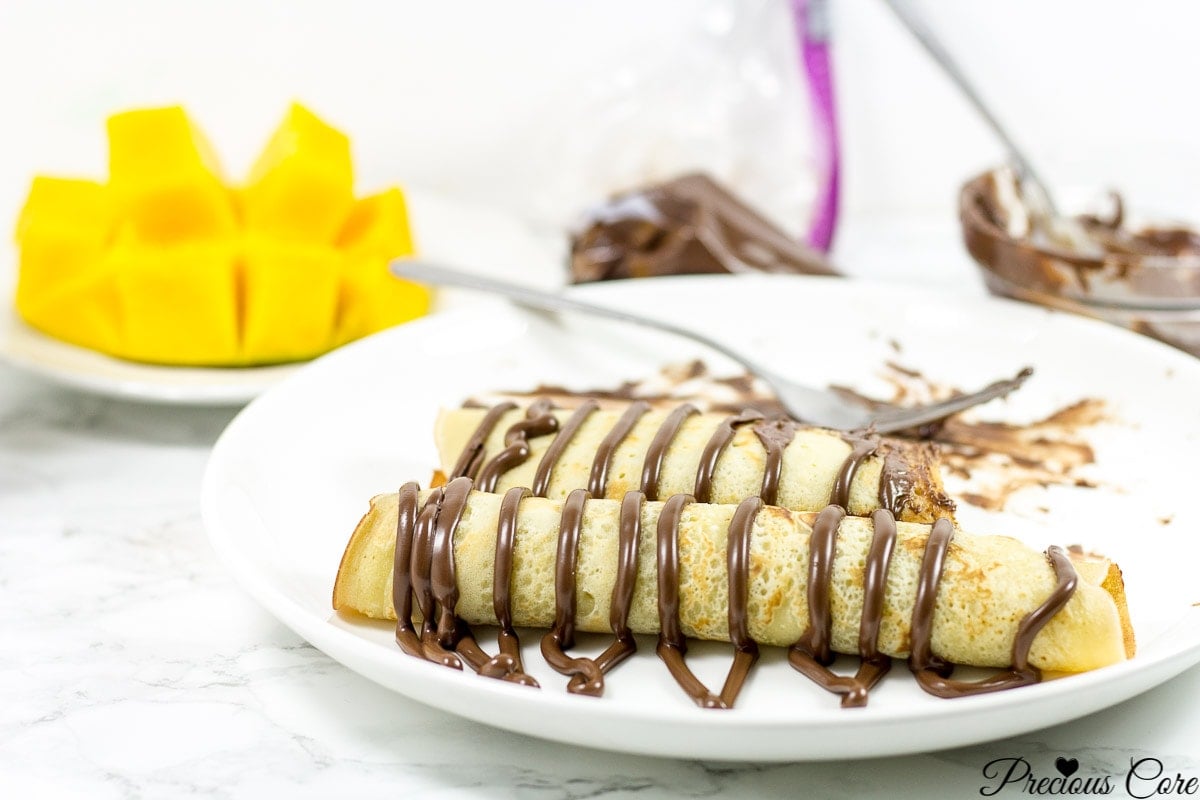 Cameroonian pancakes drizzled with chocolate.