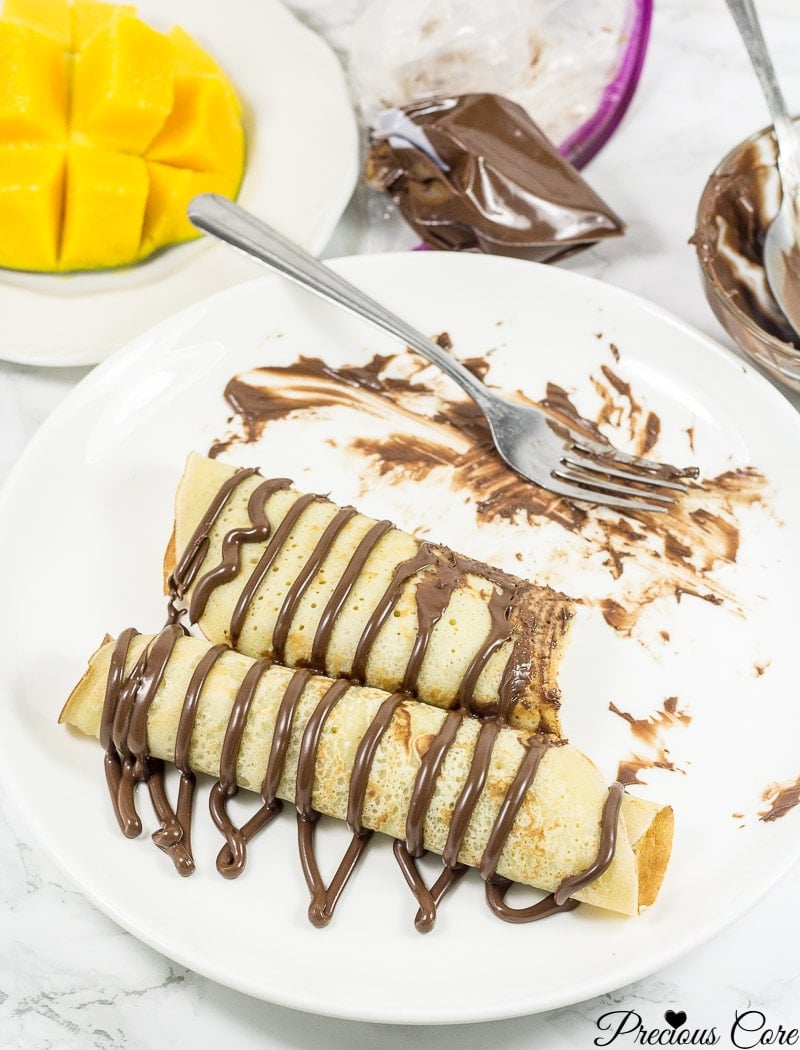 Cameroonian pancakes drizzled with chocolate.