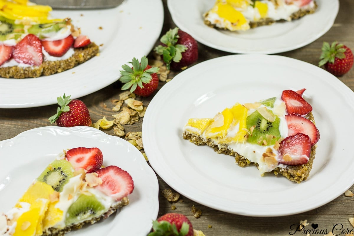 Slices of breakfast pizza on white plates.