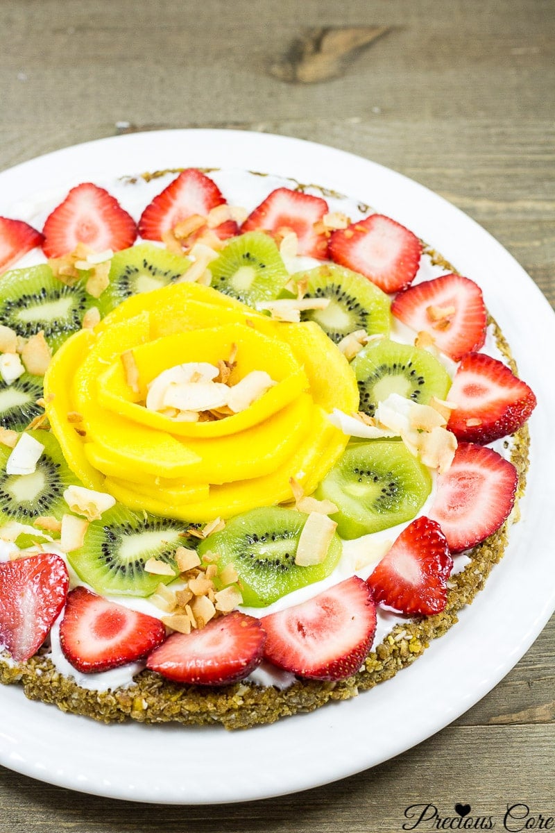 Breakfast pizza topped with strawberries, kiwi, and more.