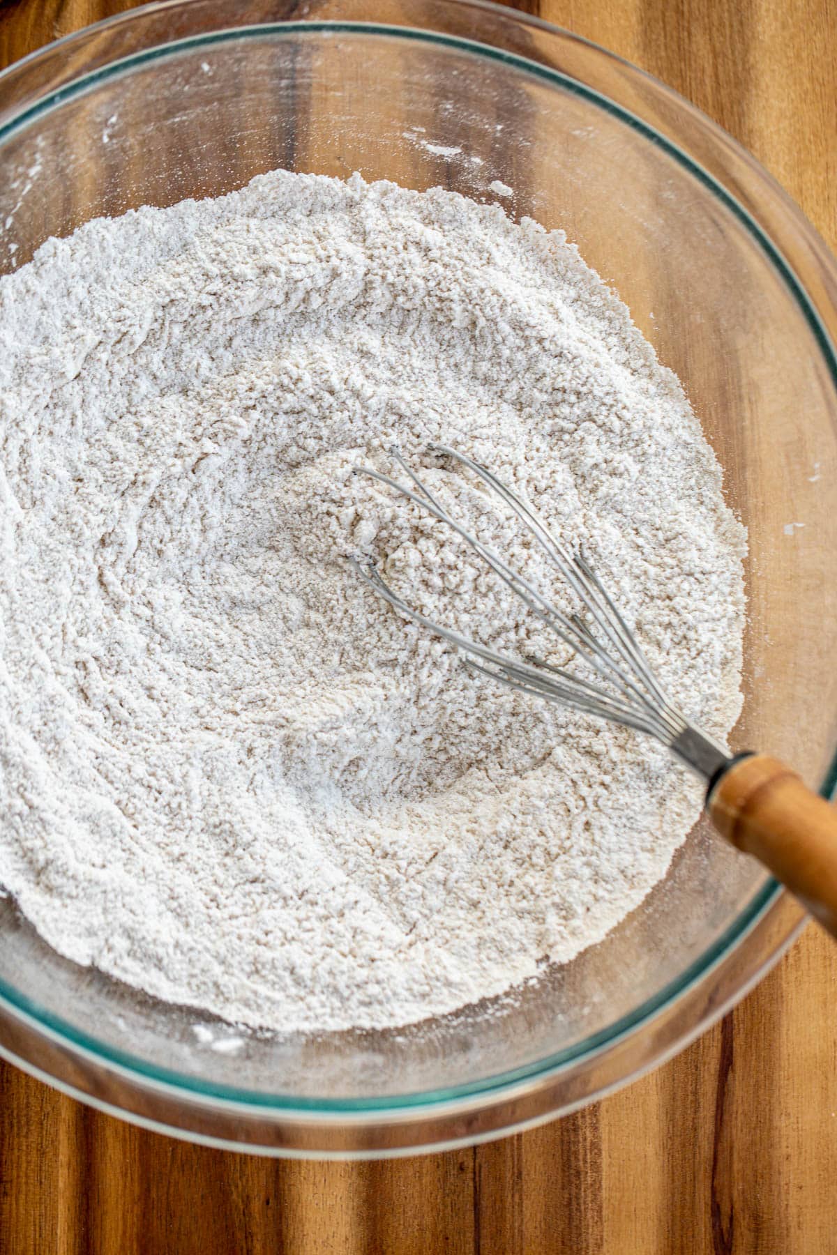 Flour and other dry ingredients for pancakes in a bowl.