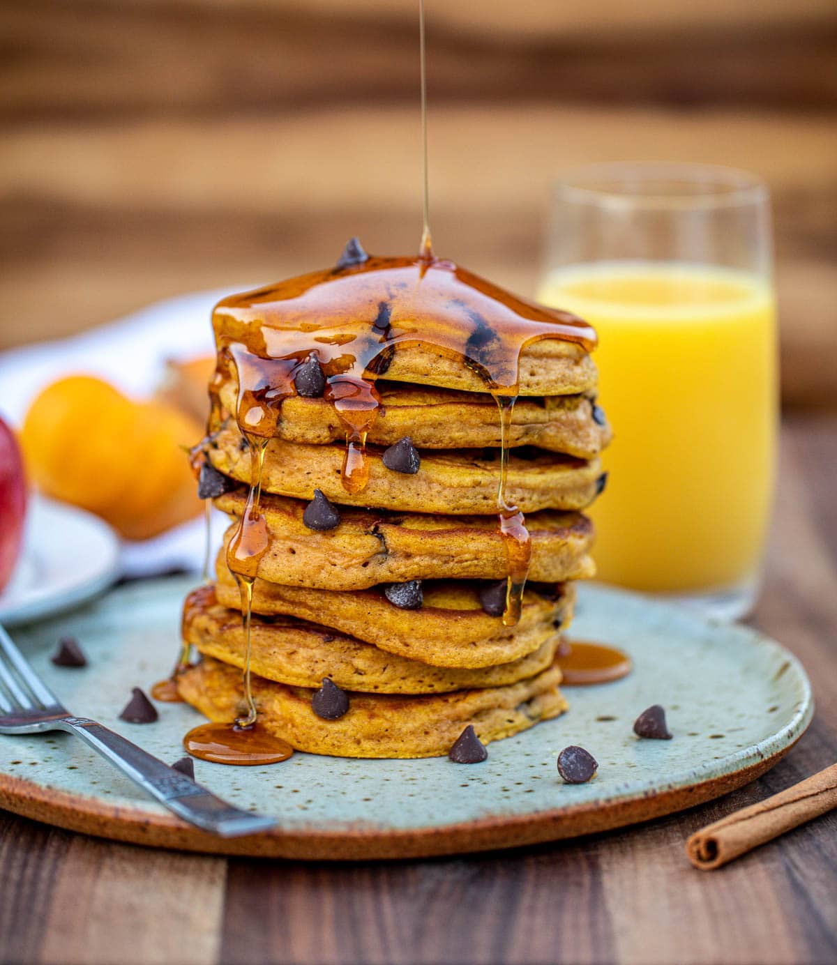Stack of pumpkin chocolate chip pancakes on a plate.