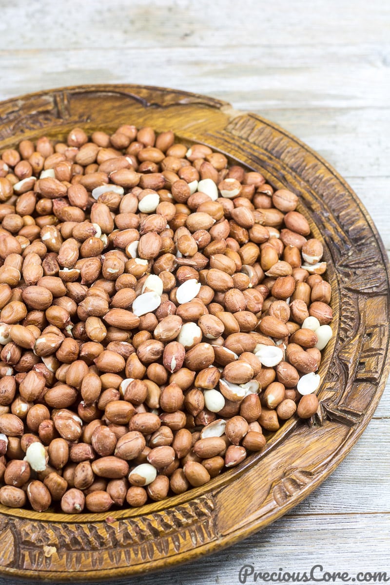 Raw groundnuts in a wooden bowl.