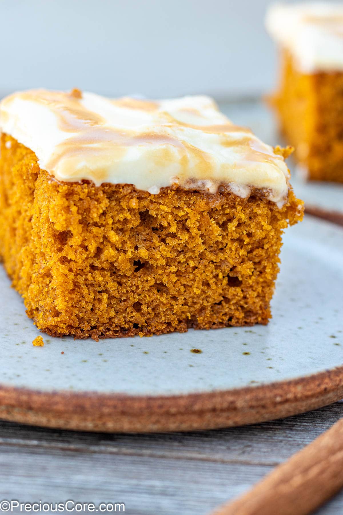 Pumpkin cake topped with cream cheese frosting.