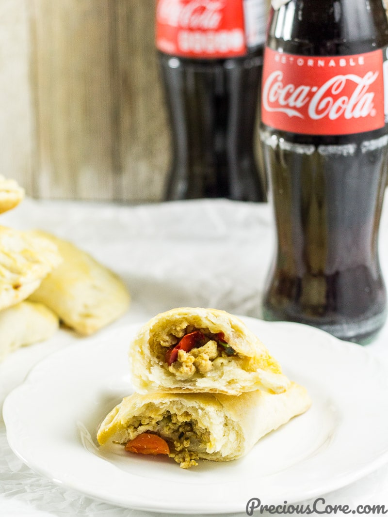 Halved Chicken Pie on a plate with a bottle of Coca-Cola.