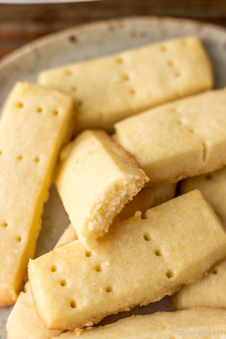 Shortbread cookies with one bitten to reveal crumbly texture