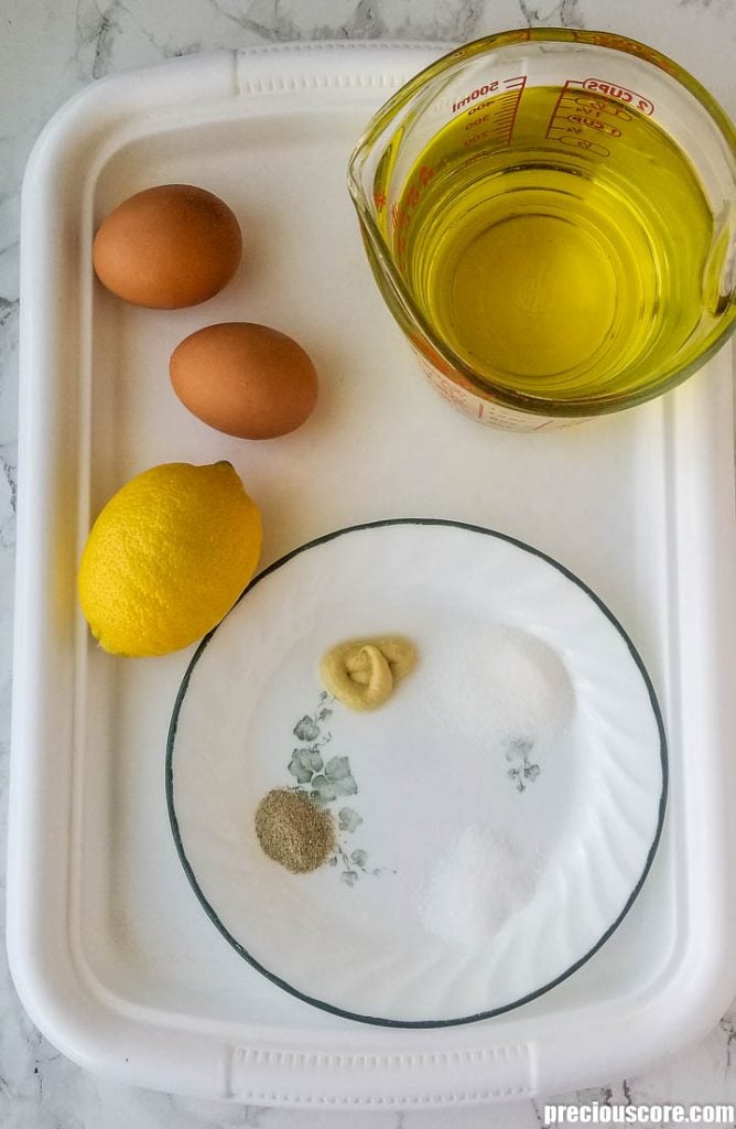 Ingredients for mayonnaise on a tray.