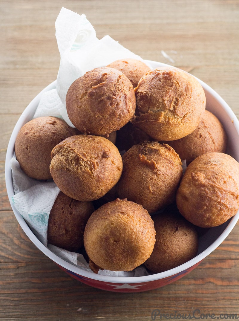 Cameroonian Beignets Soufflés on paper towels in a bowl.