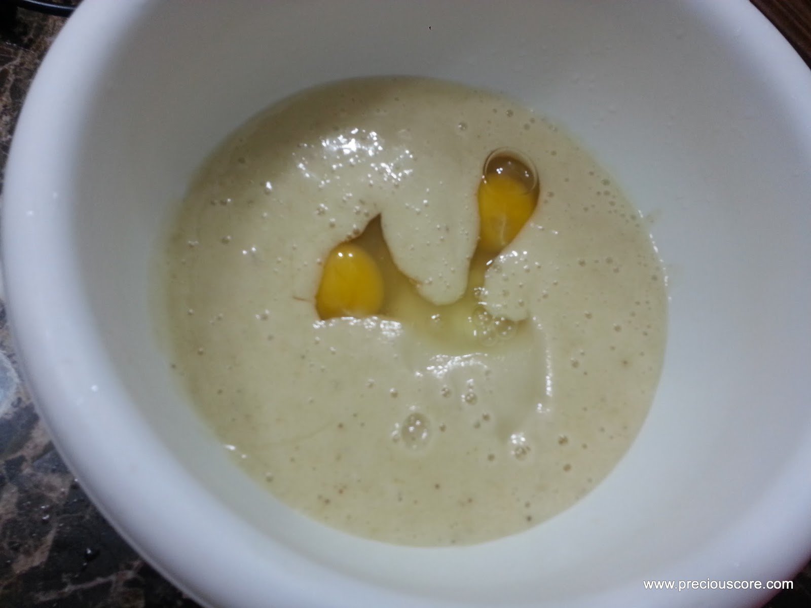 Eggs in a mixing bowl with a banana mixture.